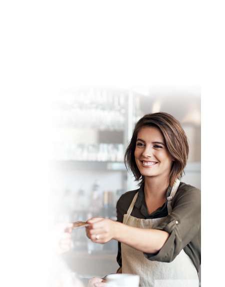 Woman accepting a credit payment at a business that uses the internet to process credit card payments