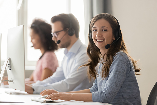 Three employees working at a call center to provide businesses with Internet, TV, Phone and Customer Service